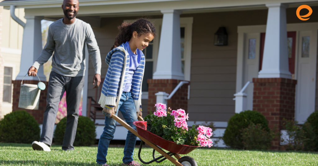 Daughter and dad gardening in front yard
