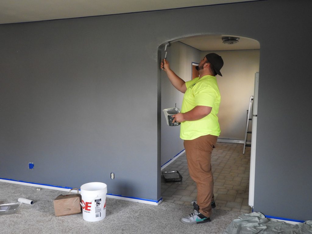 Home, Improvement man prepping door frame to paint