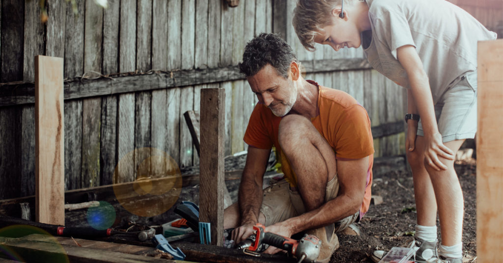 renovate Father and son repairing a damaged fence