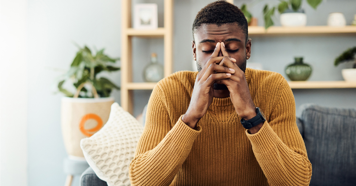 Man frustrated sitting on the couch